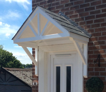 Door canopy installed above a front door, on a sunny day