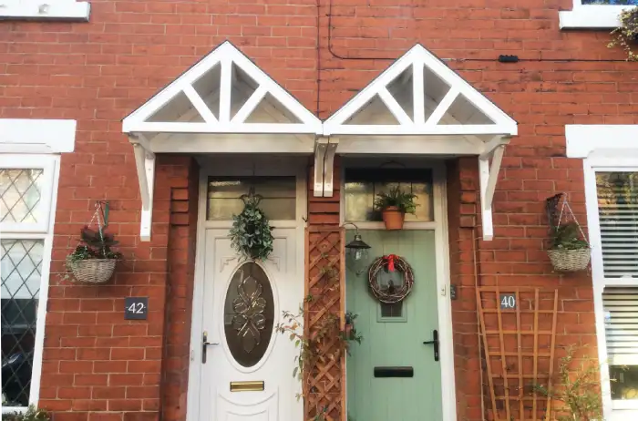 A pair of matching door canopies over two neighbouring doors