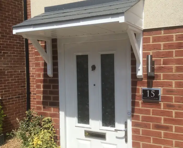 A simple lean-to door canopy installed on a residential house in the UK