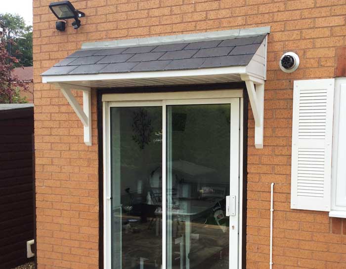 A simple lean-to door canopy installed on a residential house in the UK