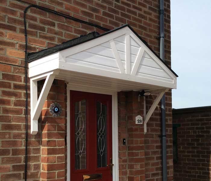 A white-painted door canopy built to order and installed